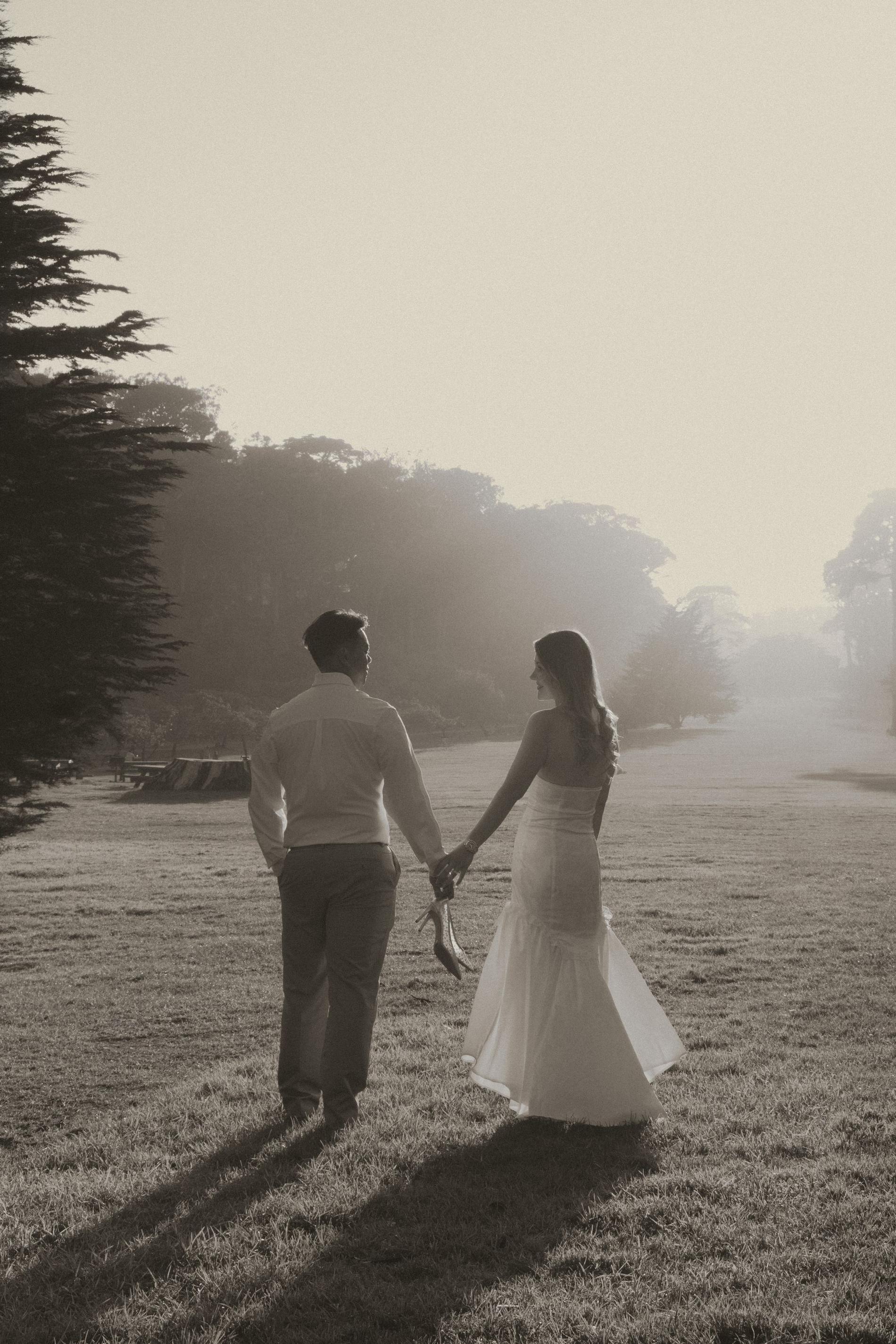 Couple walking hand in hand into the fog