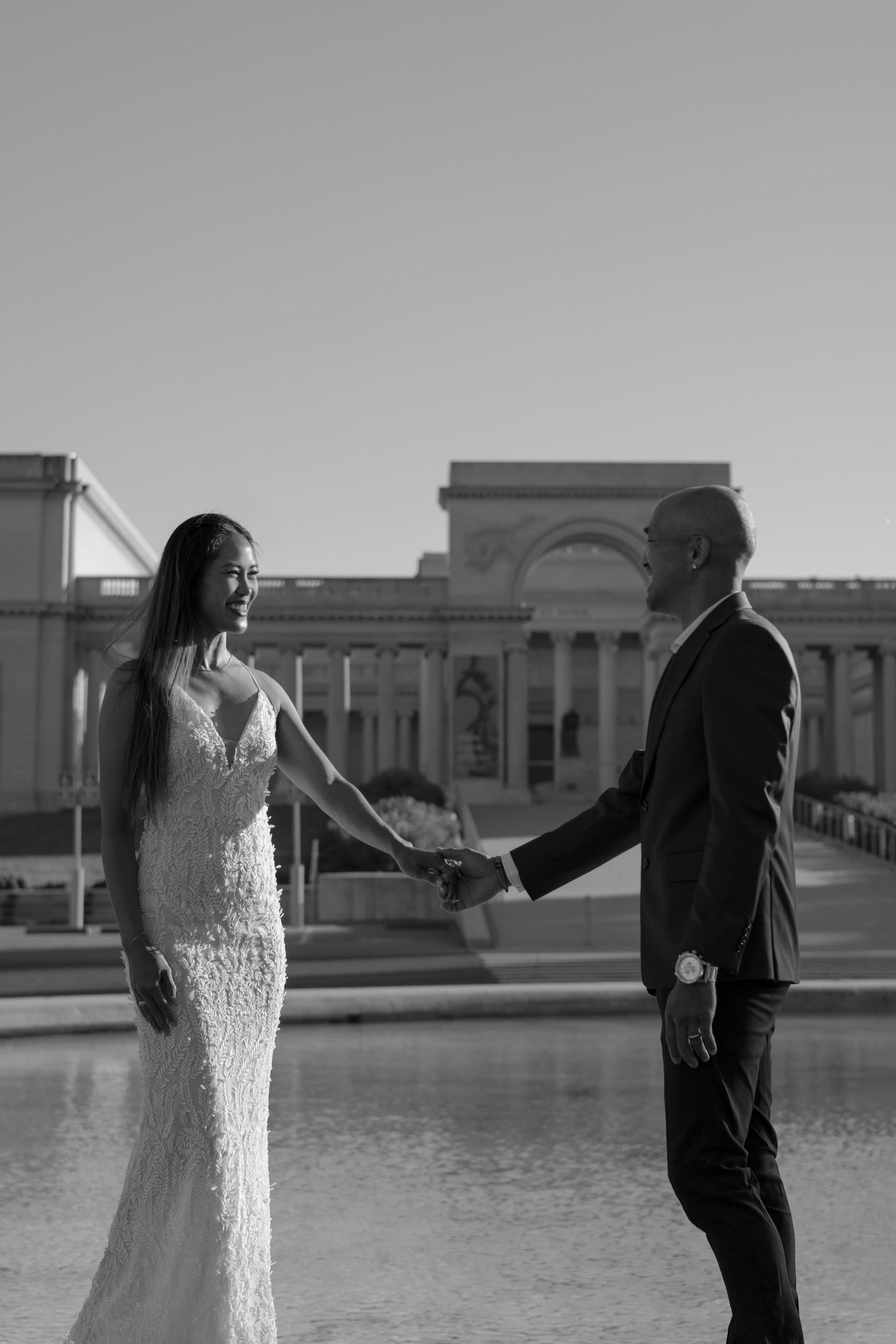 Black and white portrait of a couple holding hands at the Legion of Honor