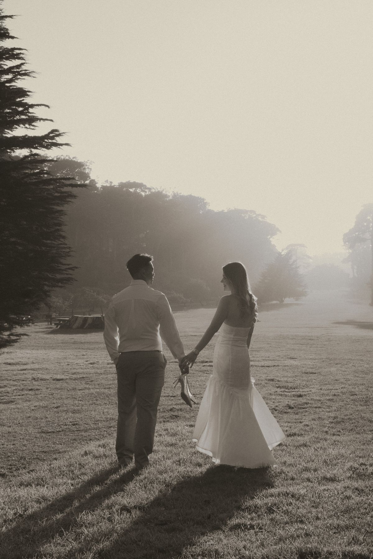 Couple walking hand in hand into the fog